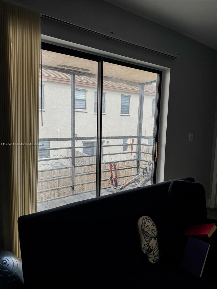 841 Northeast 207th Lane, Unit 3204 Miami, FL 33179 - Photo 33 of 37 a view of a windows and chair