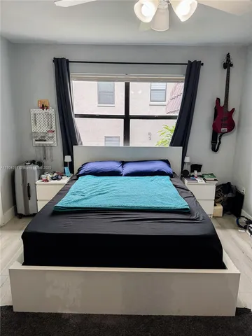 a living room with a bed furniture and a window