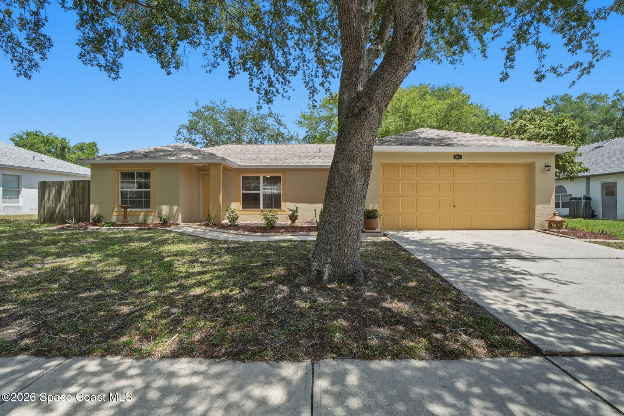2005 Lansing Street Melbourne, FL 32935 - Photo 1 of 47 a front view of a house with garden