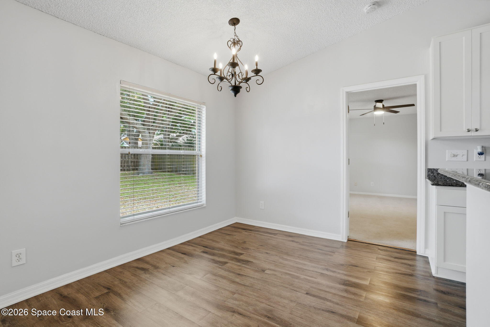 2005 Lansing Street Melbourne, FL 32935 - Photo 12 of 47 a view of an empty room with wooden floor and a window