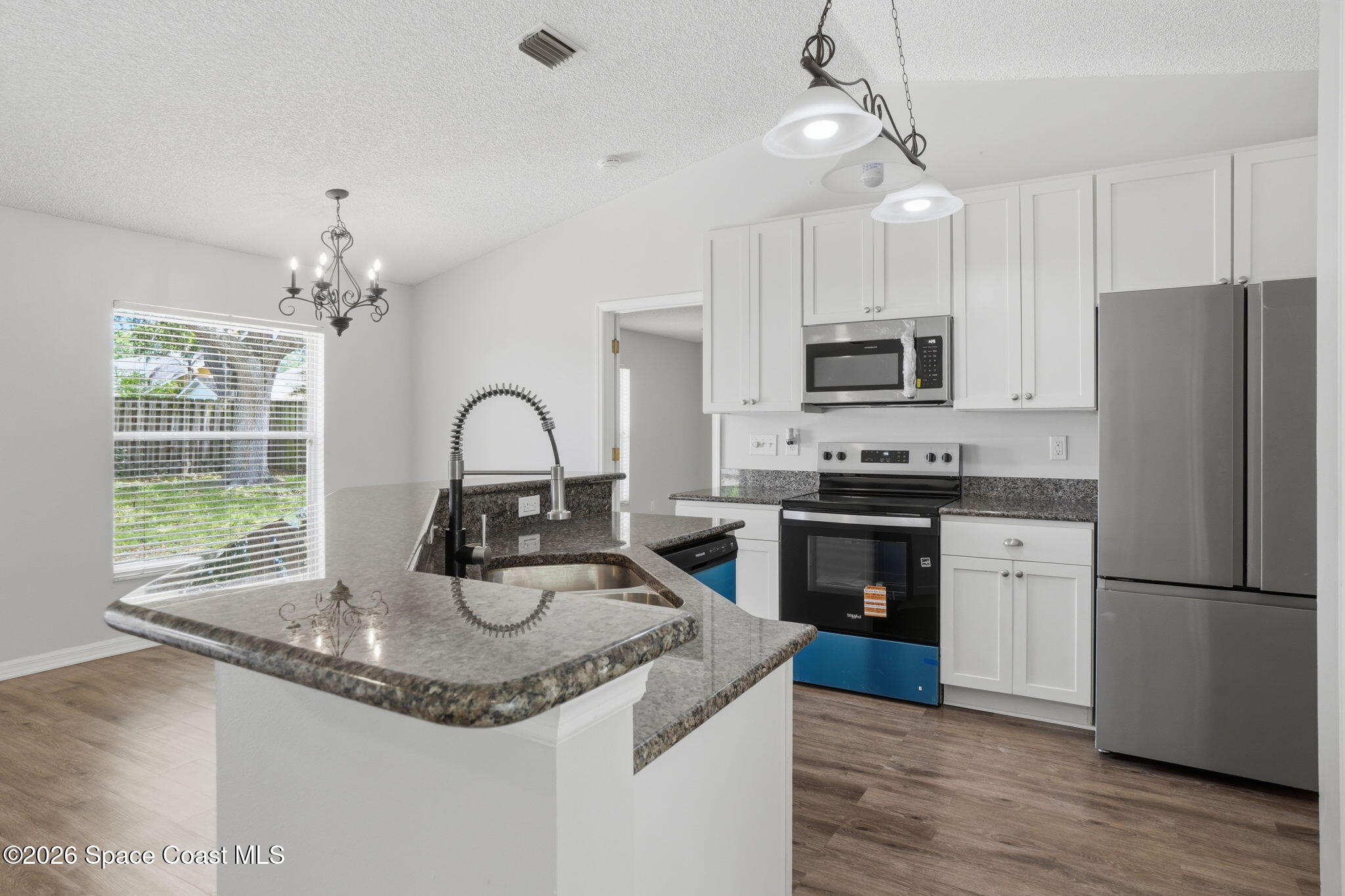 2005 Lansing Street Melbourne, FL 32935 - Photo 18 of 47 a kitchen with granite countertop a refrigerator oven a sink and dishwasher