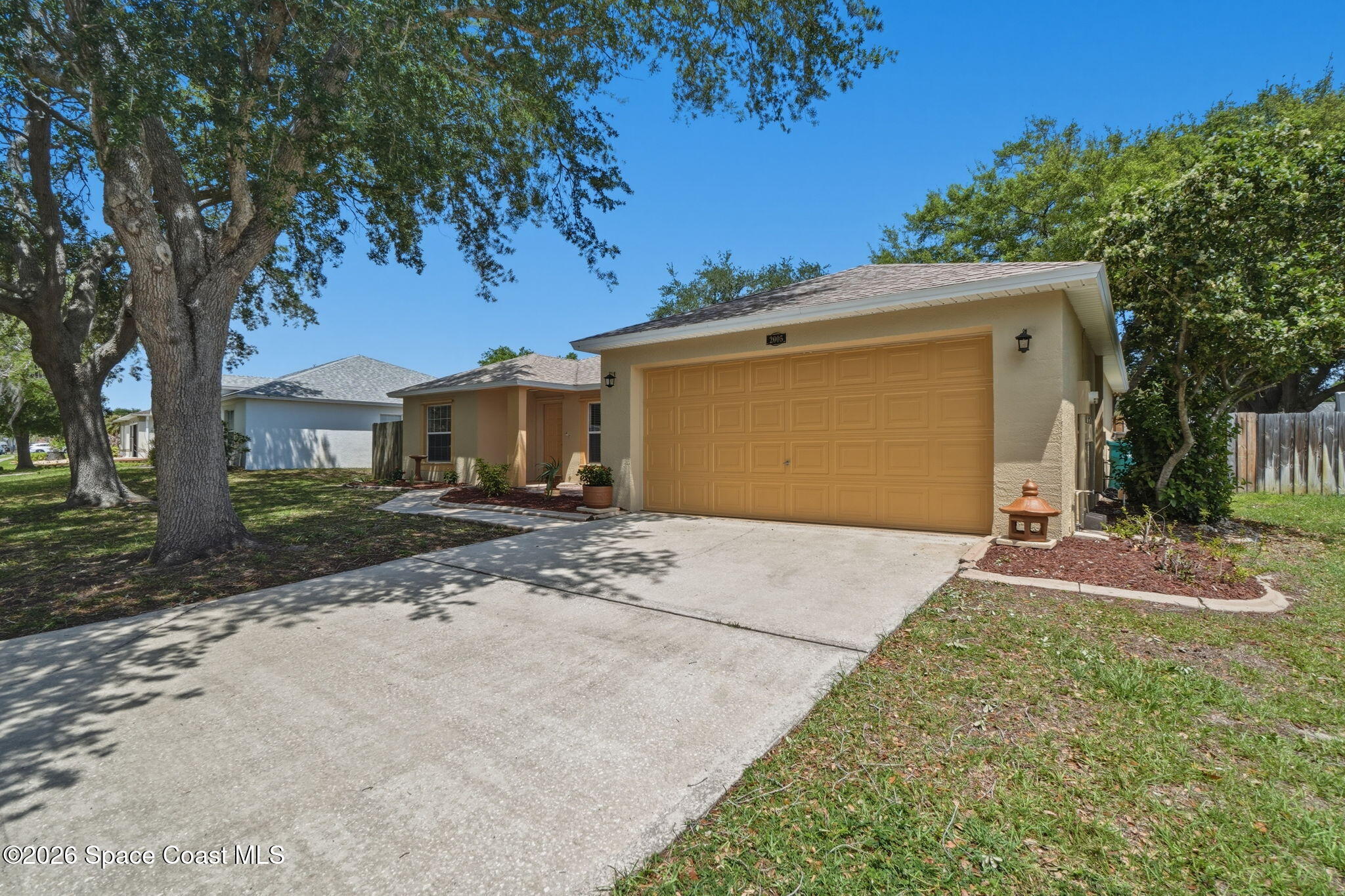 2005 Lansing Street Melbourne, FL 32935 - Photo 2 of 47 a front view of a house with a yard and garage