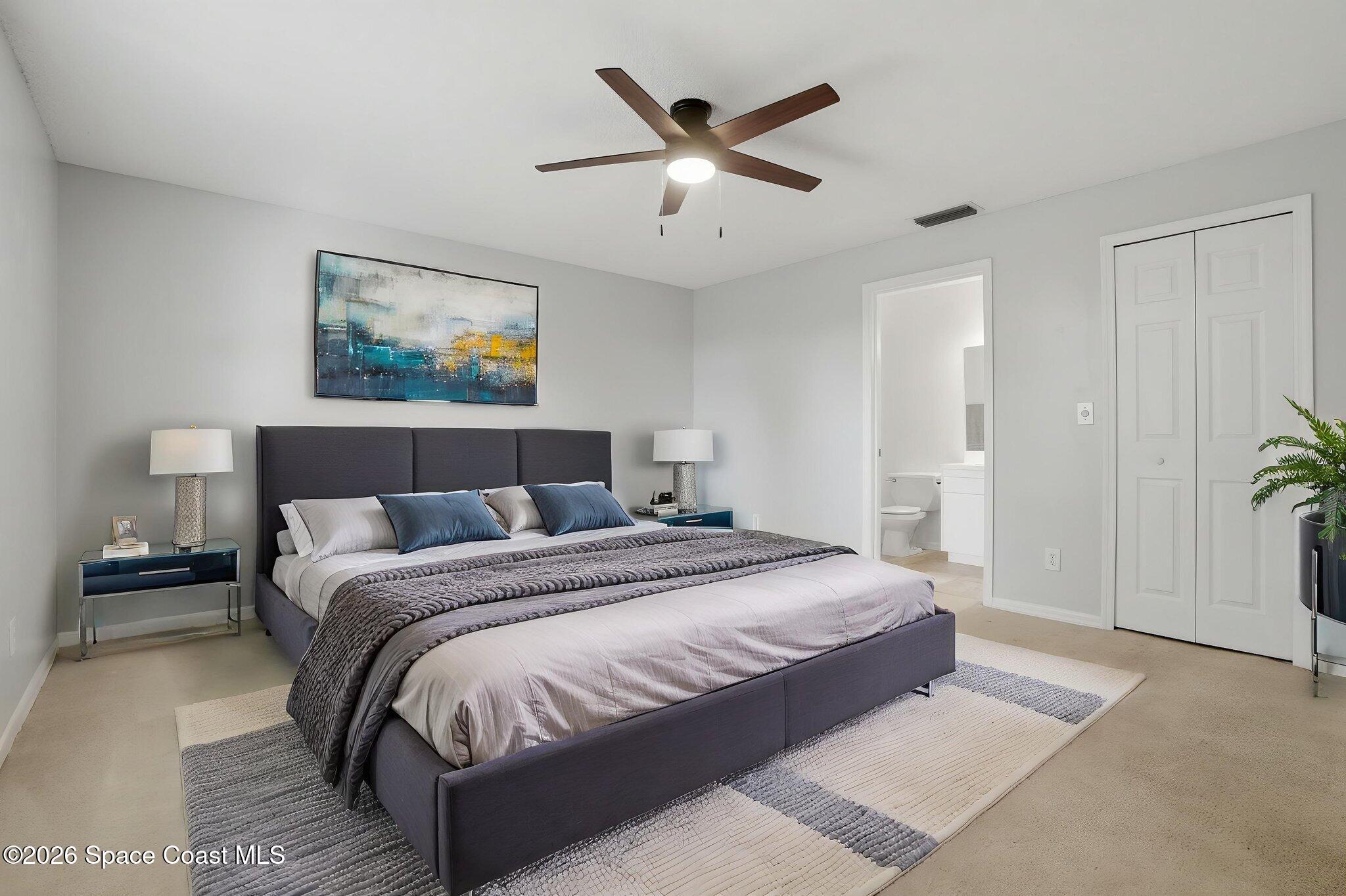 2005 Lansing Street Melbourne, FL 32935 - Photo 21 of 47 a bedroom with bed and a chandelier