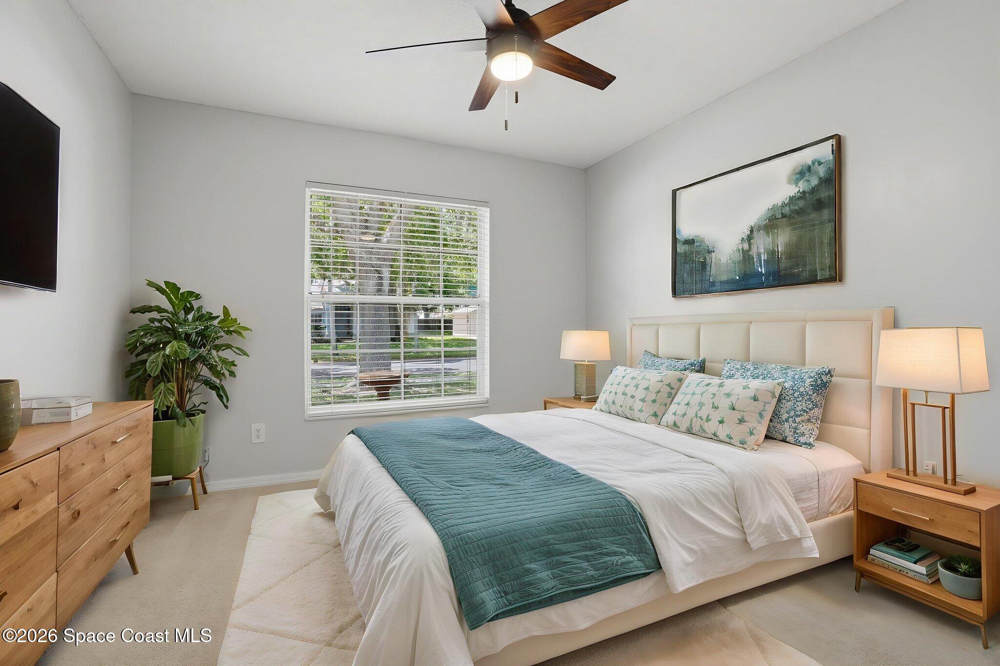 2005 Lansing Street Melbourne, FL 32935 - Photo 27 of 47 a bedroom with a bed and a potted plant