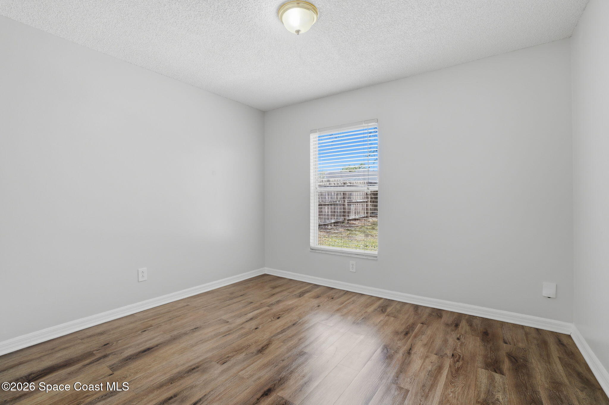 2005 Lansing Street Melbourne, FL 32935 - Photo 31 of 47 an empty room with wooden floor and windows