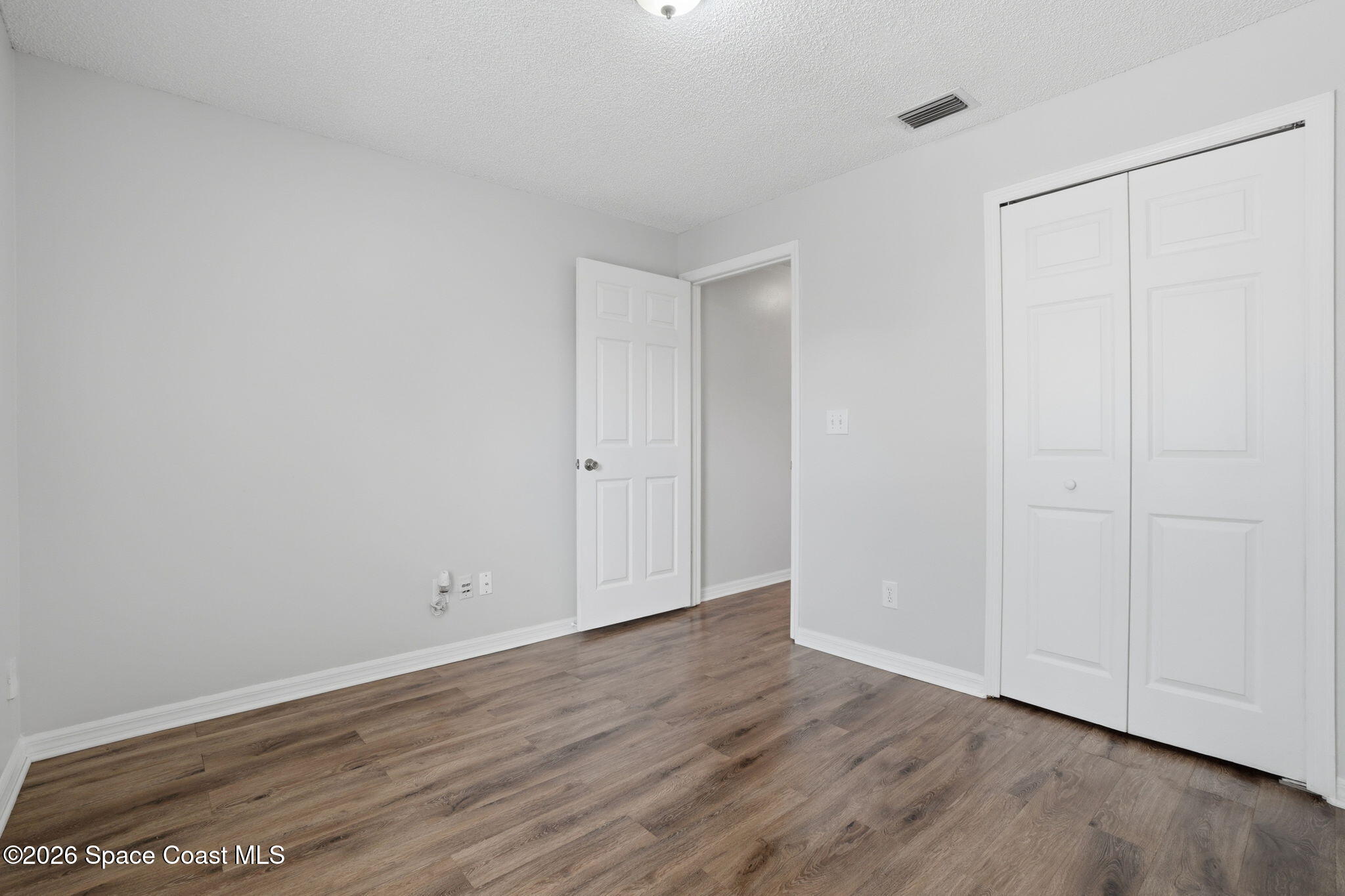 2005 Lansing Street Melbourne, FL 32935 - Photo 34 of 47 a view of an empty room with wooden floor