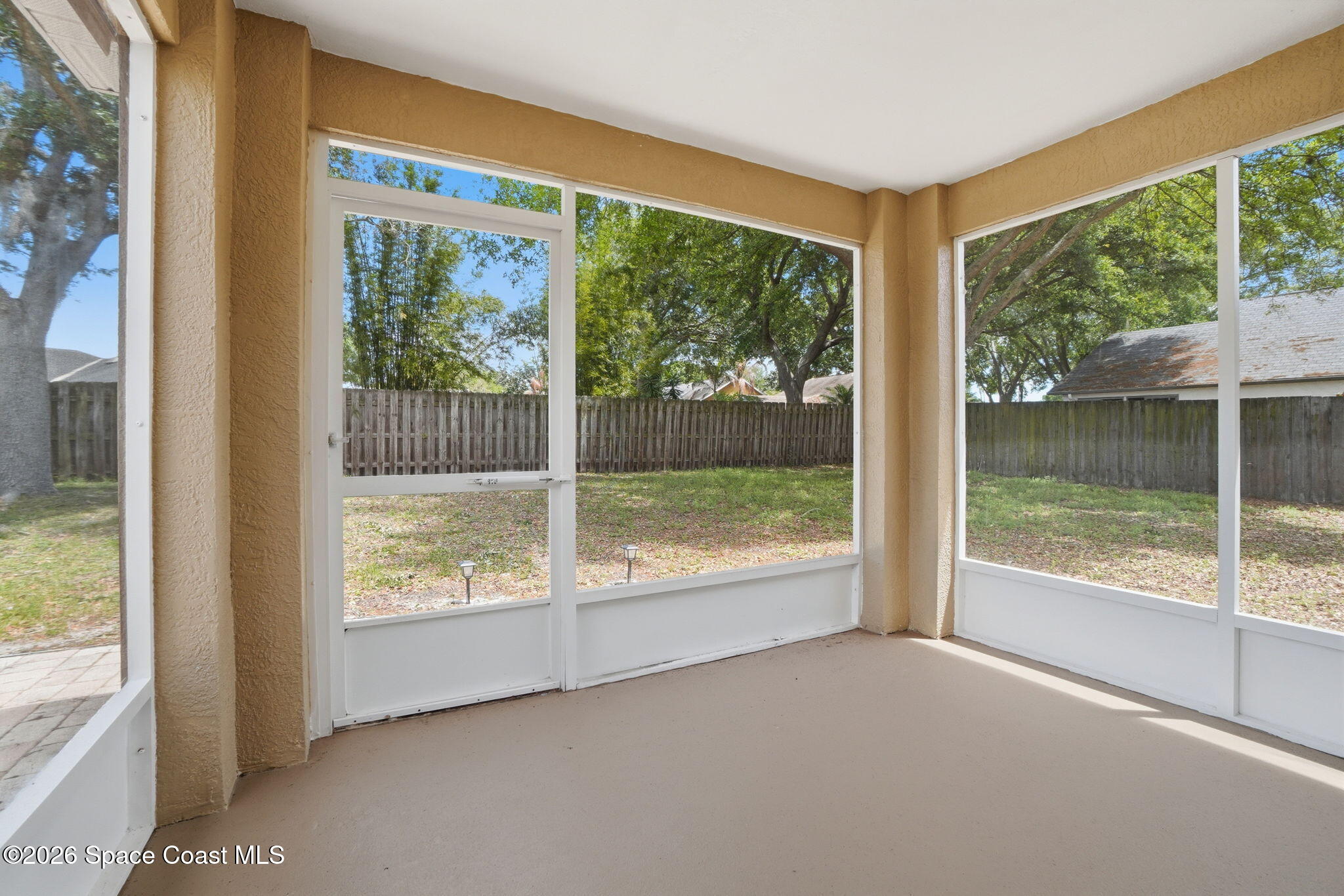 2005 Lansing Street Melbourne, FL 32935 - Photo 36 of 47 a view of an empty room with wooden floor and a floor to ceiling window