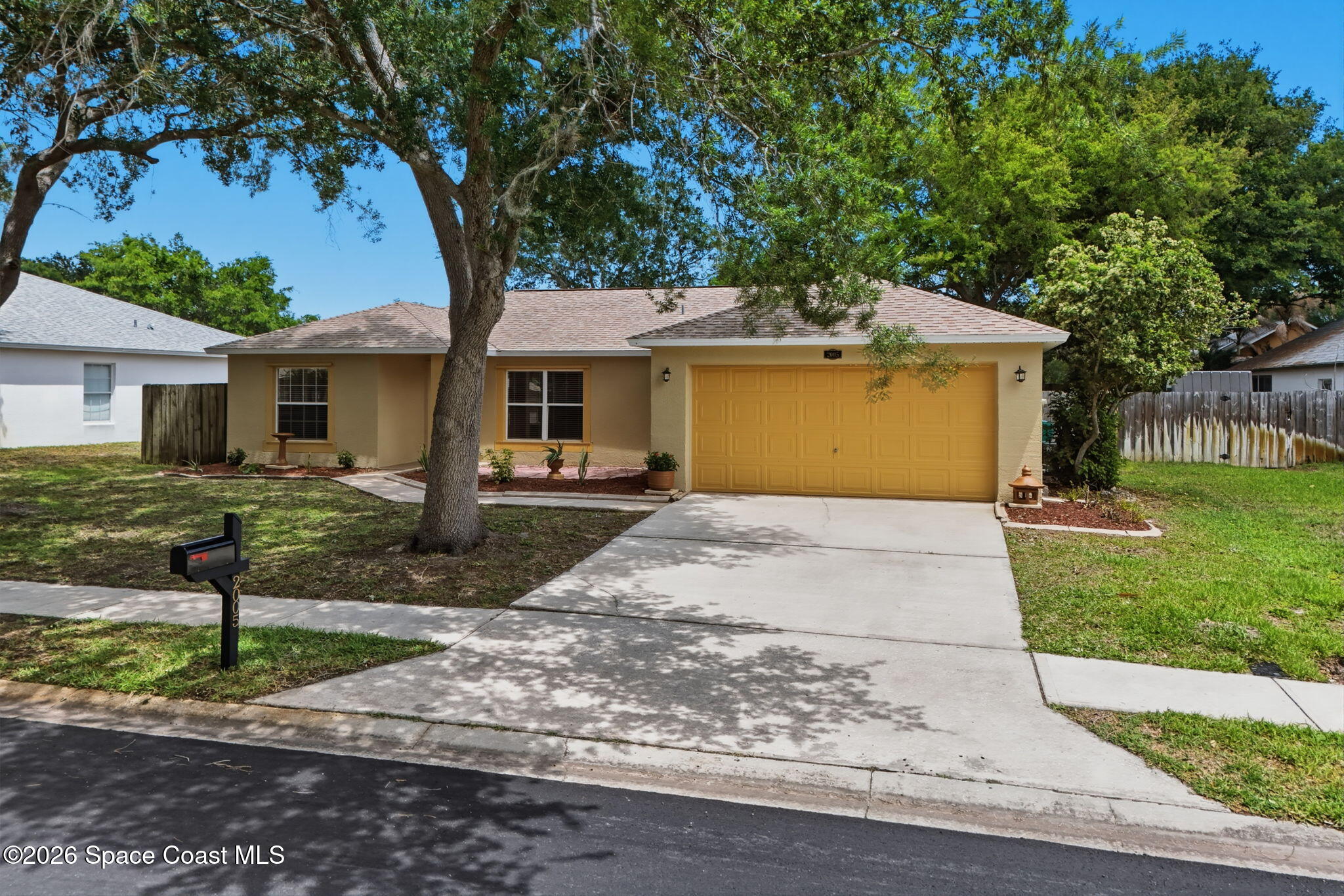 2005 Lansing Street Melbourne, FL 32935 - Photo 46 of 47 a front view of a house with a yard and trees