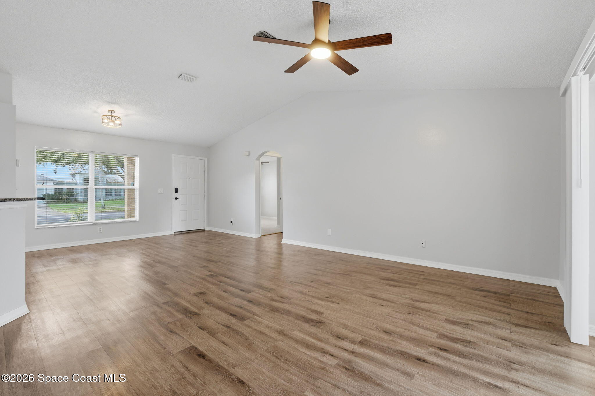 2005 Lansing Street Melbourne, FL 32935 - Photo 7 of 47 wooden floor in an empty room with a window