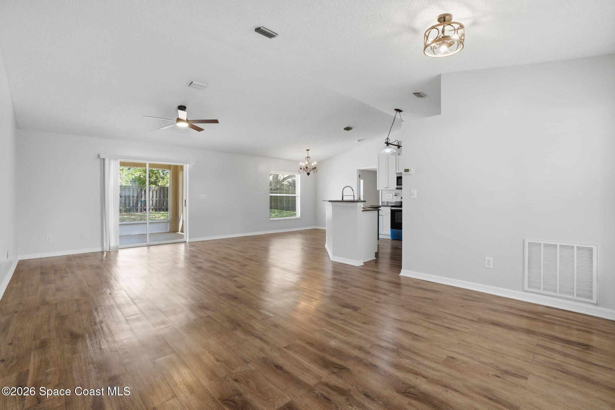 2005 Lansing Street Melbourne, FL 32935 - Photo 8 of 47 an empty room with wooden floor and windows
