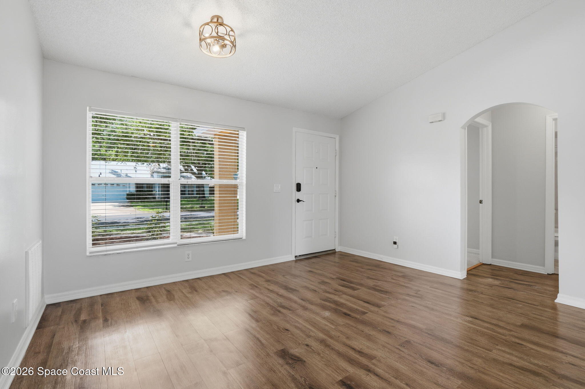 2005 Lansing Street Melbourne, FL 32935 - Photo 9 of 47 an empty room with wooden floor and windows