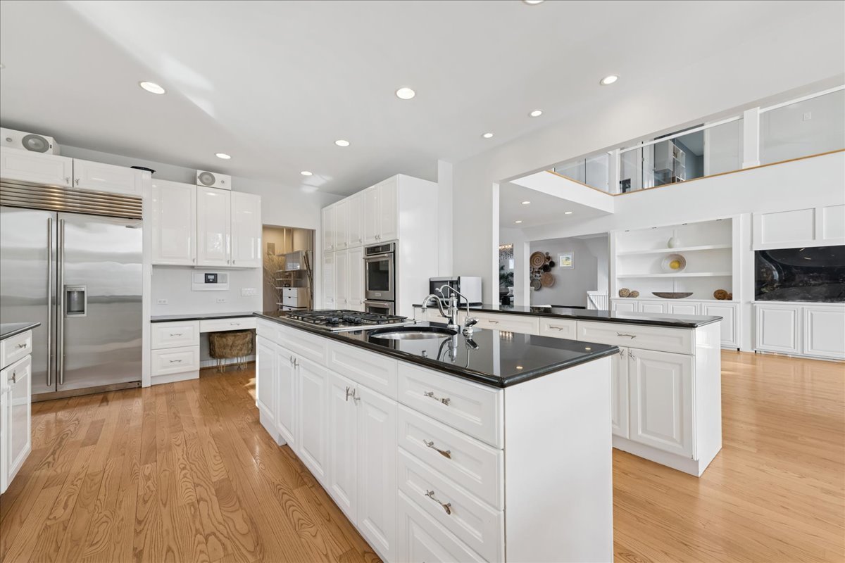 12 East Penny Road South Barrington, IL 60010 - Photo 12 of 61 a kitchen with white cabinets and stainless steel appliances