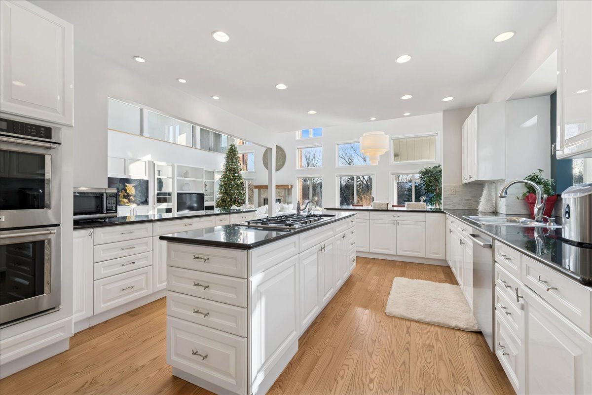 12 East Penny Road South Barrington, IL 60010 - Photo 14 of 61 a large kitchen with stainless steel appliances and white cabinets