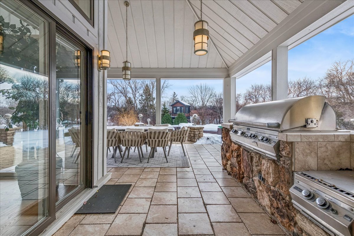 12 East Penny Road South Barrington, IL 60010 - Photo 45 of 61 a kitchen with a stove a refrigerator a dining table and chairs with the view of garden