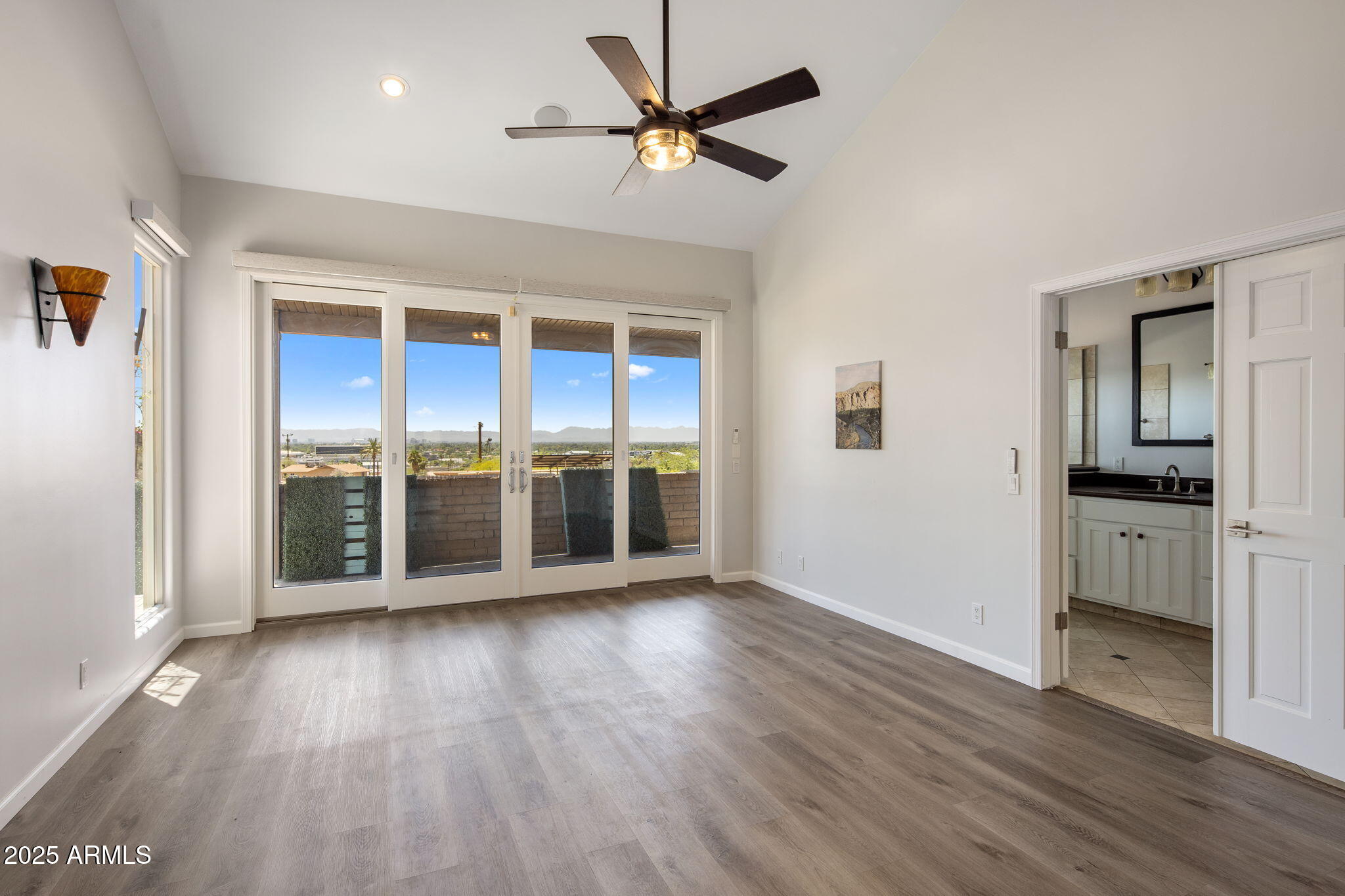 21 West Beryl Avenue Phoenix, AZ 85021 - Photo 12 of 35 an empty room with wooden floor and a ceiling fan