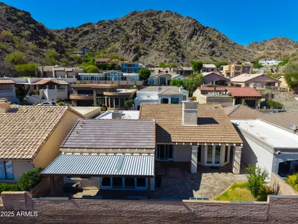 an aerial view of a house with a yard and balcony
