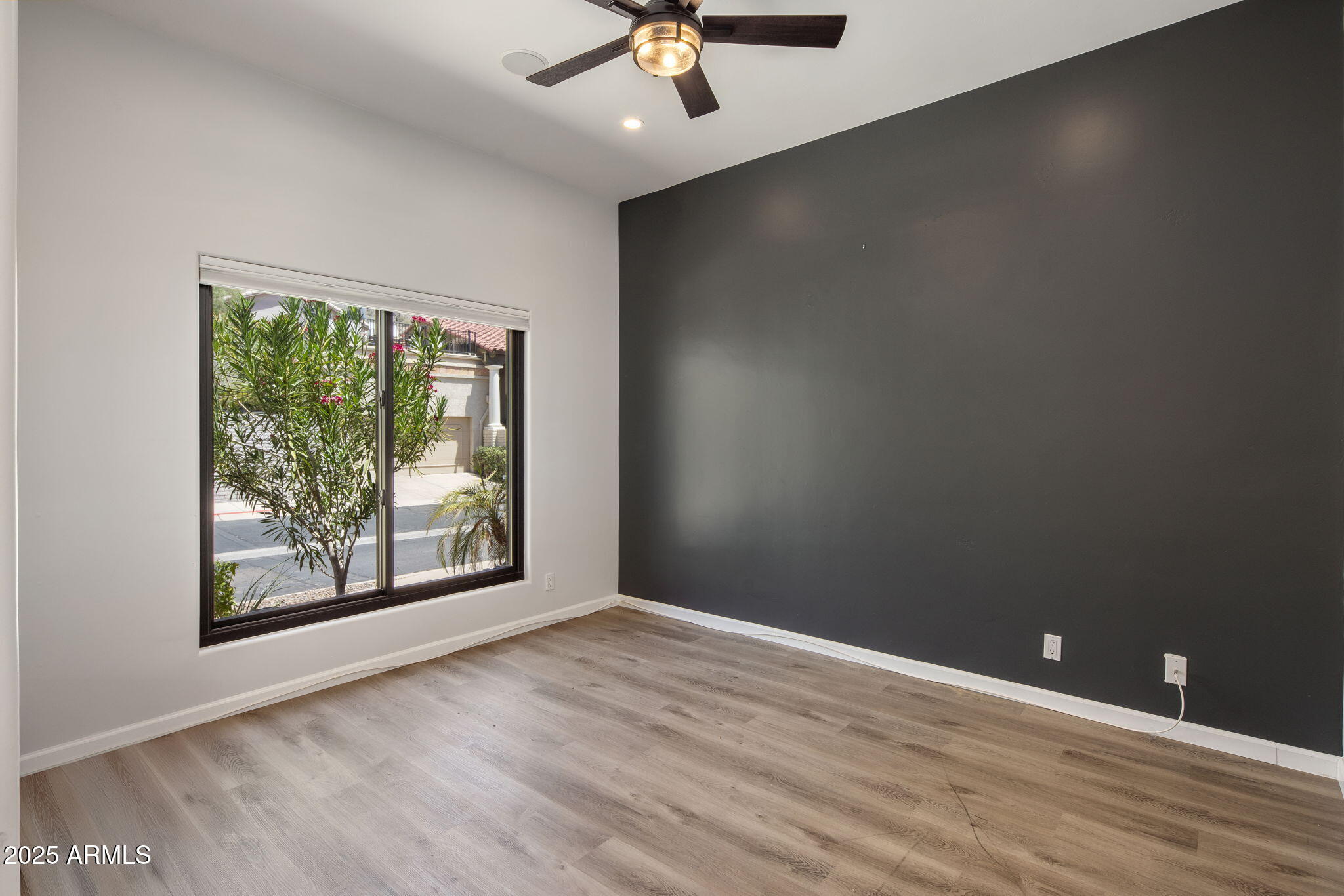 21 West Beryl Avenue Phoenix, AZ 85021 - Photo 4 of 35 an empty room with wooden floor and windows