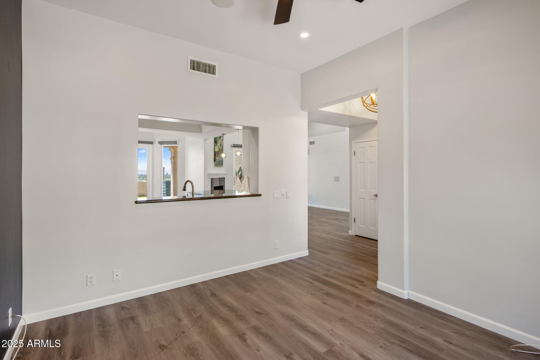 21 West Beryl Avenue Phoenix, AZ 85021 - Photo 7 of 35 an empty room with wooden floor and mirror