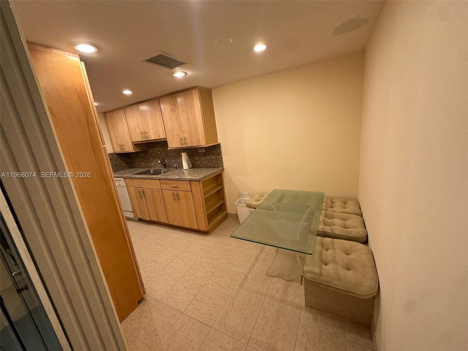 6039 Collins Avenue, Unit 1625 Miami Beach, FL 33140 - Photo 11 of 45 a view of kitchen with furniture and wooden floor