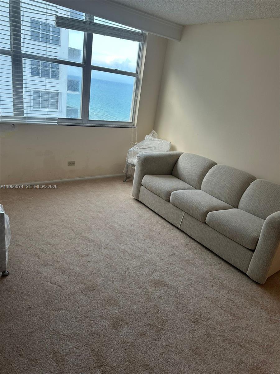 6039 Collins Avenue, Unit 1625 Miami Beach, FL 33140 - Photo 12 of 45 a living room with furniture and a window