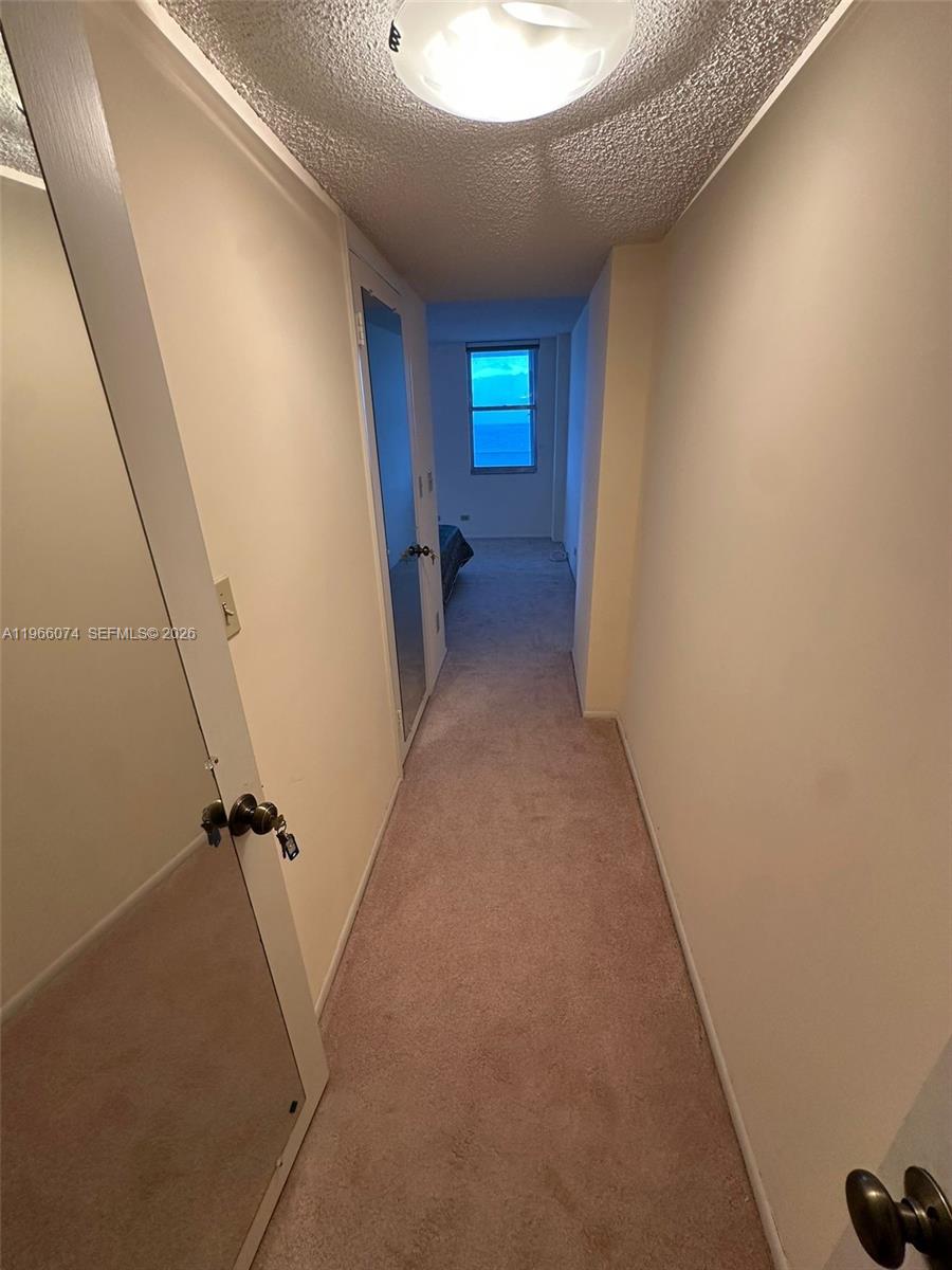 6039 Collins Avenue, Unit 1625 Miami Beach, FL 33140 - Photo 15 of 45 a view of hallway with window