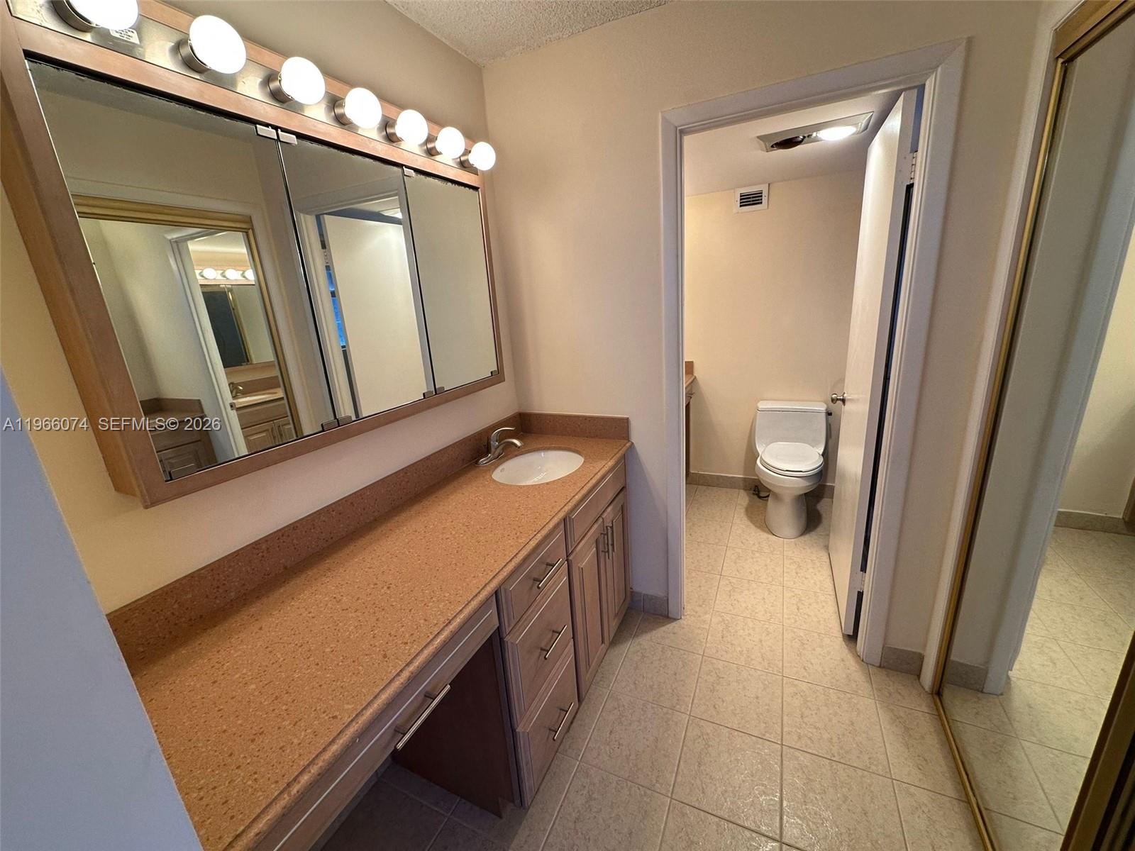 6039 Collins Avenue, Unit 1625 Miami Beach, FL 33140 - Photo 18 of 45 a bathroom with a sink and a mirror