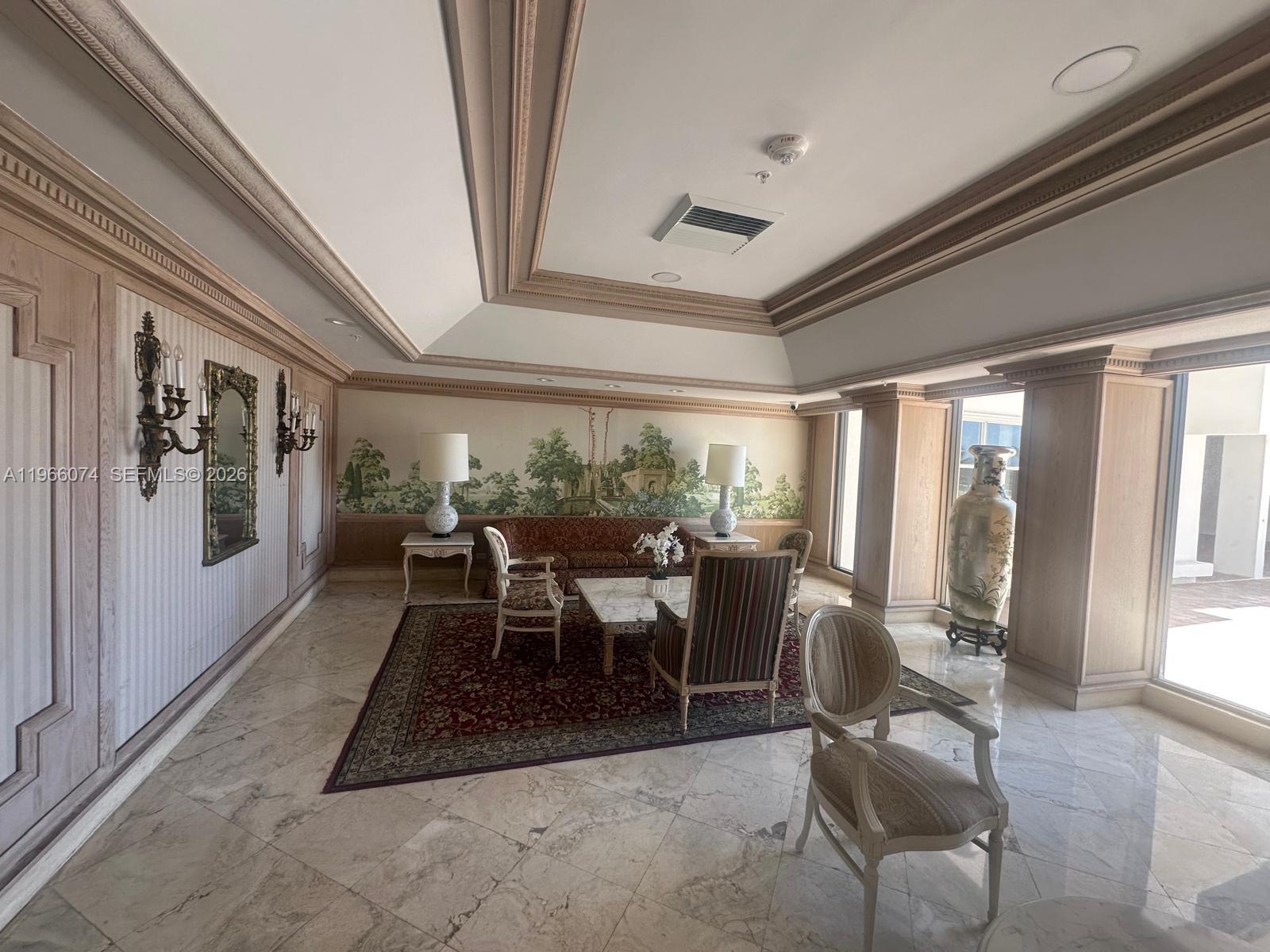 6039 Collins Avenue, Unit 1625 Miami Beach, FL 33140 - Photo 22 of 45 a dining room with furniture a chandelier and wooden floor