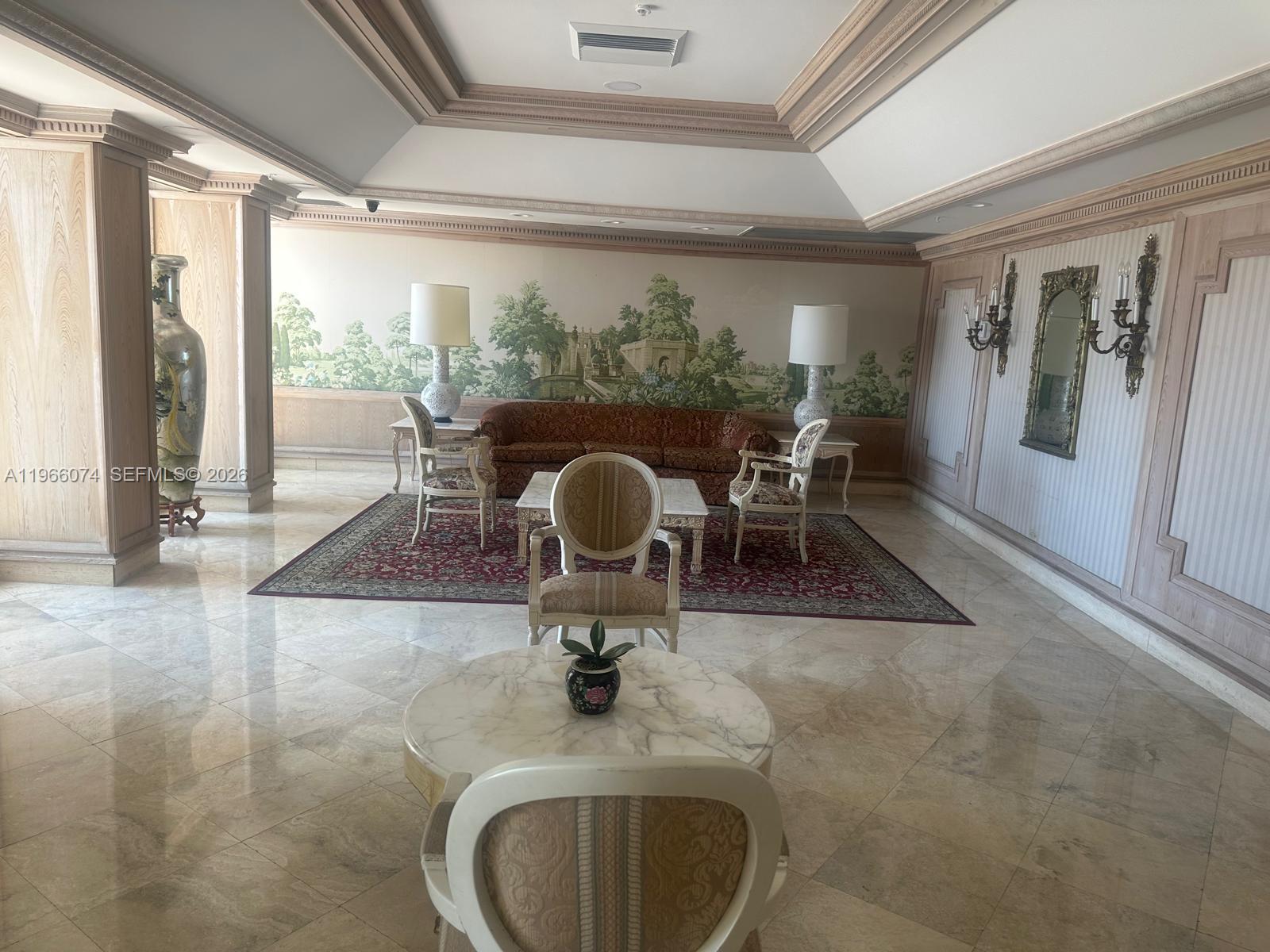 6039 Collins Avenue, Unit 1625 Miami Beach, FL 33140 - Photo 32 of 45 a dining room with wooden floor and a floor to ceiling window