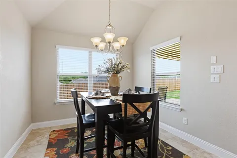 a view of a dining room with furniture wooden floor and chandelier