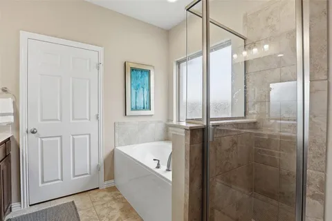 a bathroom with a bathtub and shower
