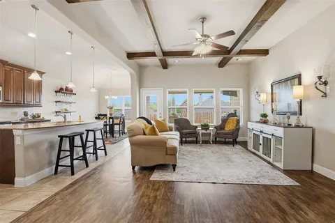 a very nice looking living room with stainless steel appliances furniture