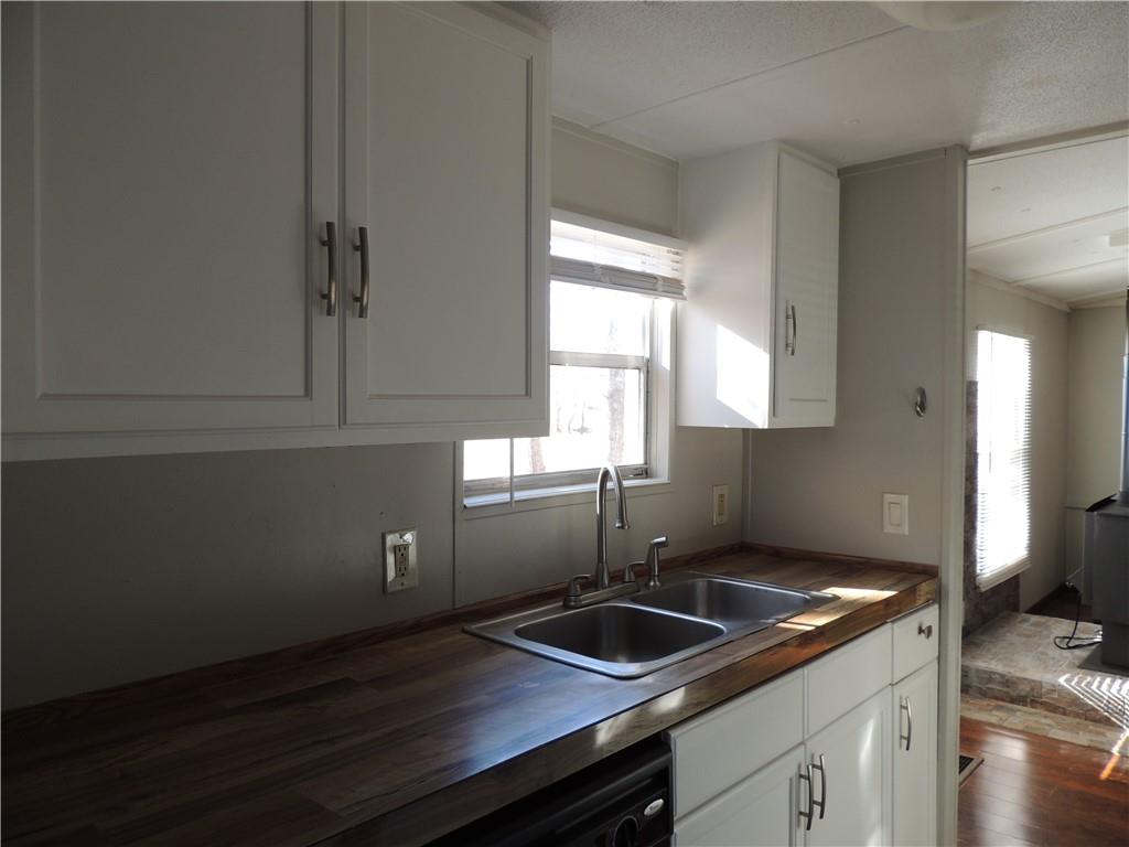 209 Horton Road Dahlonega, GA 30533 - Photo 33 of 41 a kitchen with granite countertop a sink and a window