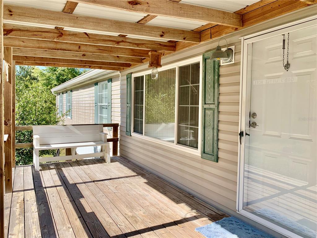 12752 Southeast 9th Place Gainesville, FL 32641 - Photo 2 of 53 a balcony with table and chairs
