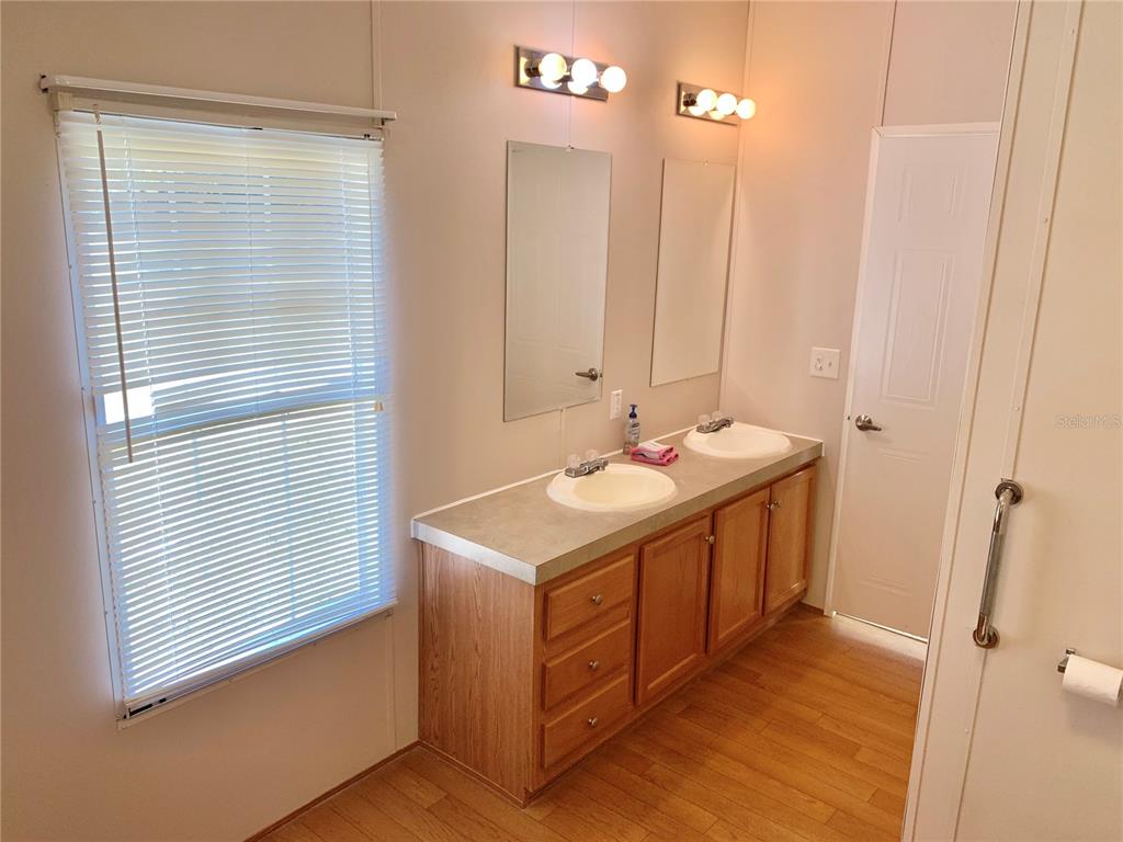 12752 Southeast 9th Place Gainesville, FL 32641 - Photo 27 of 53 a bathroom with a sink a mirror and a shower