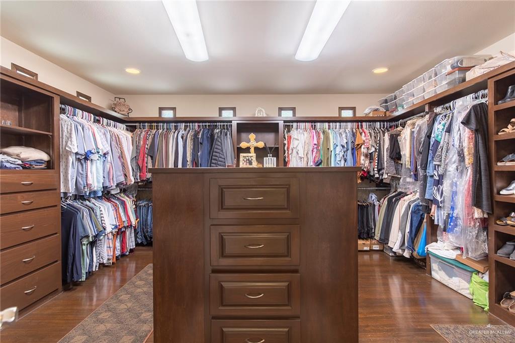 605 South Hutto Road Donna, TX 78537 - Photo 14 of 45 Designed for a fashion enthusiast, the primary suite features a massive walk-in closet. It boasts custom built-ins, abundant hanging rails, shelving, storage and an oversized center island.