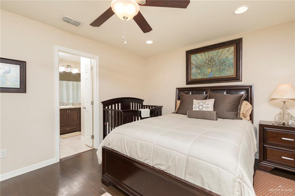 605 South Hutto Road Donna, TX 78537 - Photo 17 of 45 a bedroom with a large bed and a wooden floor