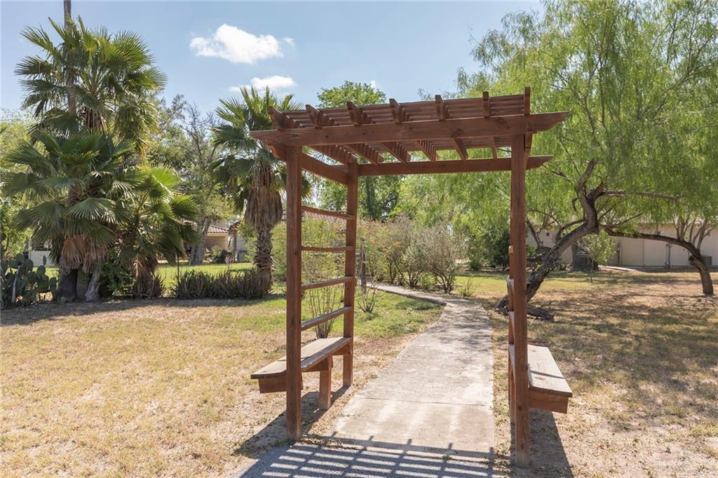 605 South Hutto Road Donna, TX 78537 - Photo 42 of 45 The back of the property features a second pergola and more mature trees and fauna. A working private well helps to keep the property watered.