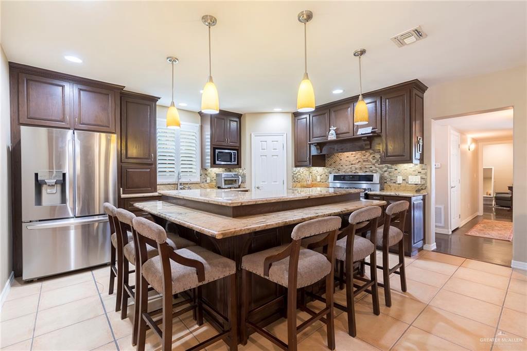 605 South Hutto Road Donna, TX 78537 - Photo 9 of 45 The updated kitchen features stainless steel appliances, granite counter tops, walk-in pantry and seating for casual dining.