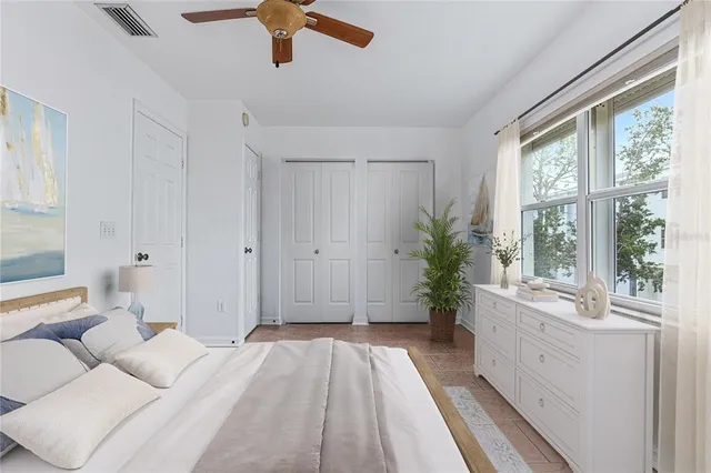 a spacious bedroom with a bed and a large window