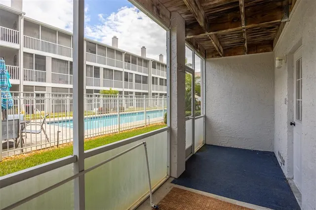 a view of a house with swimming pool and sitting area