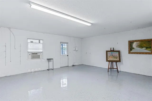 an aerial view of a house with a garden and lake view