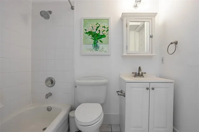 a spacious bedroom with a bed a couch and a window