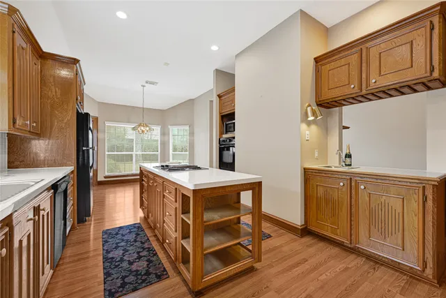 a kitchen with stainless steel appliances granite countertop a stove a sink and a refrigerator