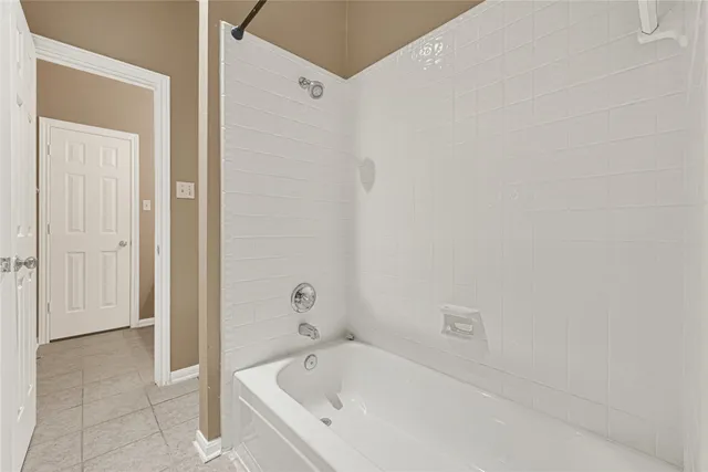 a white bath tub sitting next to a shower