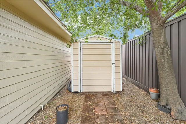 a view of a house with a door and wooden walls