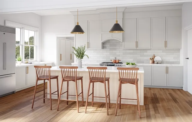 a kitchen with stainless steel appliances a dining table chairs and wooden floor