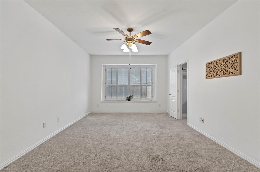 2617 Hollow Ridge Drive Denton, TX 76210 - Photo 11 of 32 an empty room with chandelier fan and windows