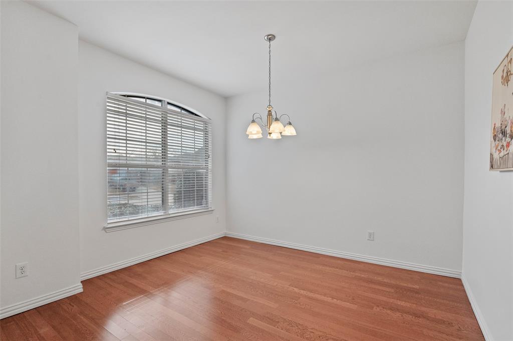 2617 Hollow Ridge Drive Denton, TX 76210 - Photo 16 of 32 an empty room with wooden floor and windows