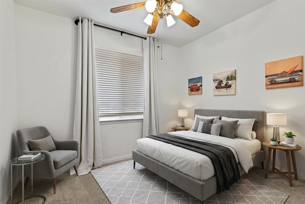 2617 Hollow Ridge Drive Denton, TX 76210 - Photo 21 of 32 a bedroom with a bed and a chandelier