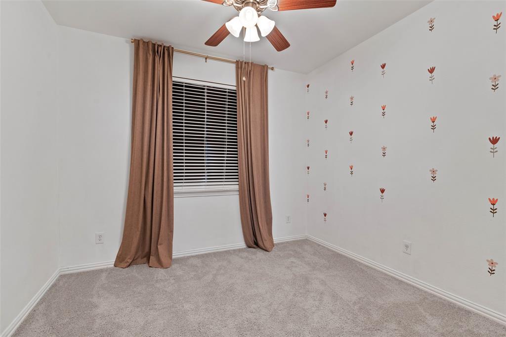 2617 Hollow Ridge Drive Denton, TX 76210 - Photo 24 of 32 a view of a livingroom with an empty space and a ceiling fan
